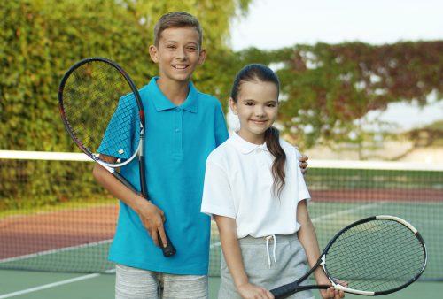 Portrait,Of,Caucasian,Cute,Cheerful,Small,Kids,Holding,Rackets,And