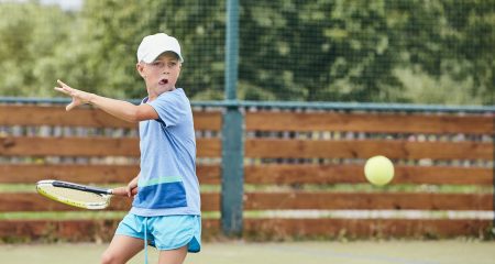 Little boy playing tennis